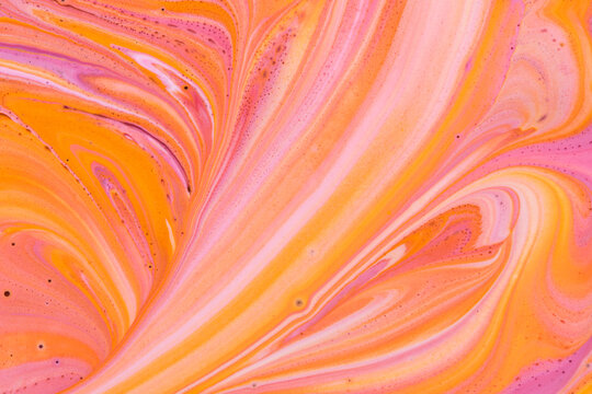 Bright abstract pattern mixed pink, orange and white fluid acrylic paint.