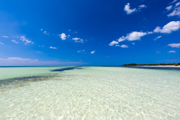 Tropical sandy beach and an exotic view of the Atlantic Ocean against a blue sky with clouds in Cuba, Caribbean – background for projects, wallpaper © anettastar