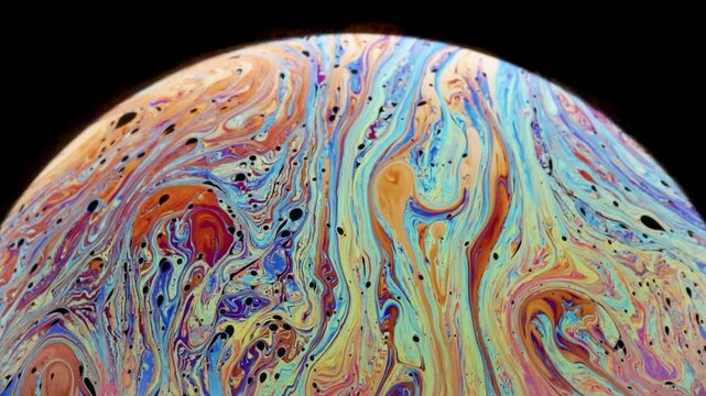 Soap bubble floating gracefully, showcasing its stunning, ever-changing hues in this mesmerizing close-up slow motion video while showing signs of loosing cohesion.