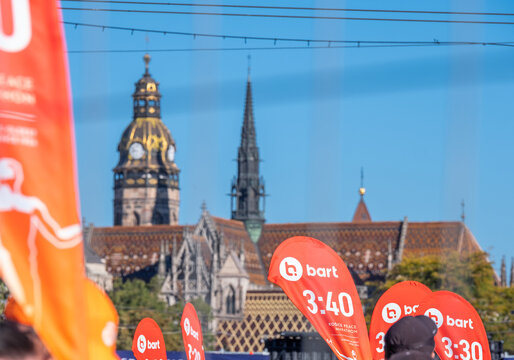 KOSICE, SLOVAKIA - OCTOBER 4, 2026: Pacemaker flags raised during Kosice Peace Marathon with landmark Gothic St. Elizabeth Cathedral tower in city center background