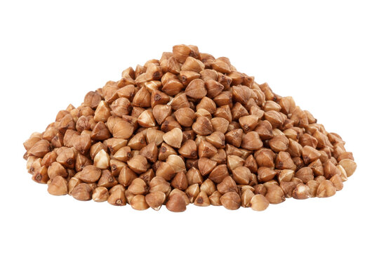Large pile of raw, uncooked buckwheat groats forms a textured mound, isolated on a clean white background