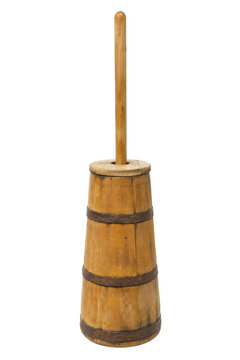 Old traditional wooden butter churn with a long plunger, featuring rustic metal bands, isolated on a clean white background