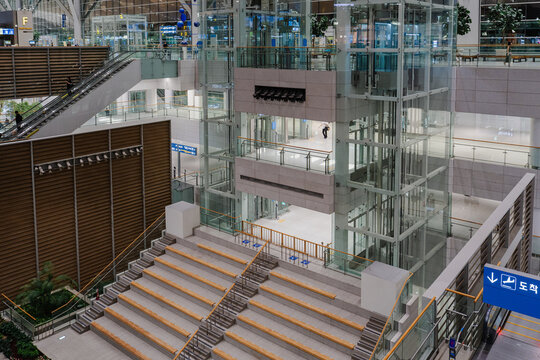 September 23, 2026, Incheon, South Korea - Interior view of Incheon International Airport Terminal 2 with escalators, glass elevators, and multi-level architecture.