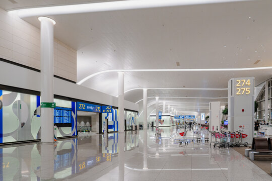 September 23, 2026, Incheon, South Korea - Modern interior of Incheon International Airport Terminal 2 with gate signs and luggage carts