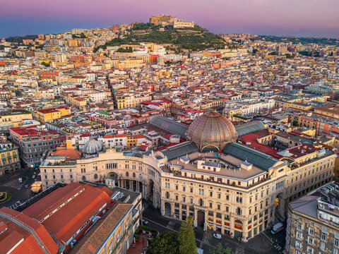 Sunrise view of Galleria Umberto in Naples. NAPLES, ITALY - OCTOBER 3, 2026: Aerial view of Galleria Umberto I and Castel Sant Elmo during colorful sunrise.