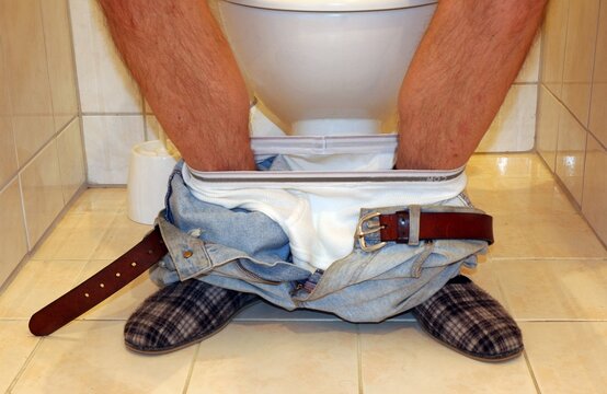 Man sitting on a toilet
