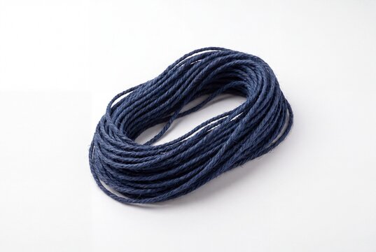 Coiled Navy Blue Jute Twine Cord on White Background