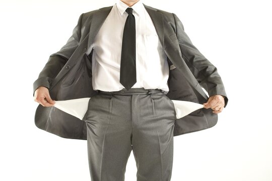 Bankrupt businessman turning out his empty pockets