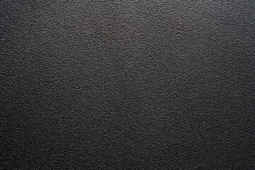 Black plastic texture full frame abstract rough dark background. Top view dark grey matte textured surface. Black grainy powder coated metal, industrial plastic or asphalt for modern design © OlegD