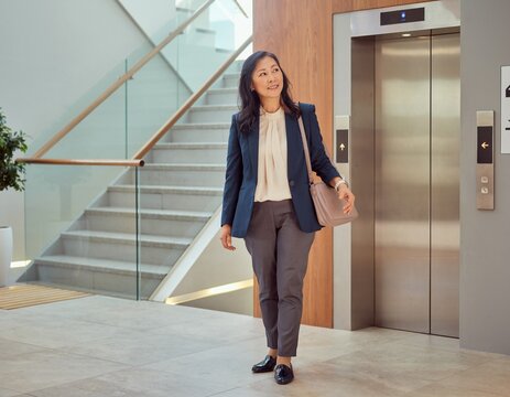 Businesswoman Considers Stairs or an Elevator