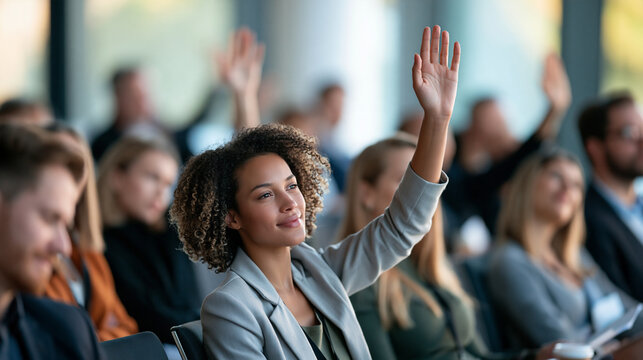 Diverse professionals participating in a modern seminar, people raising hands to ask questions, business education, conference learning, professional development, workshop