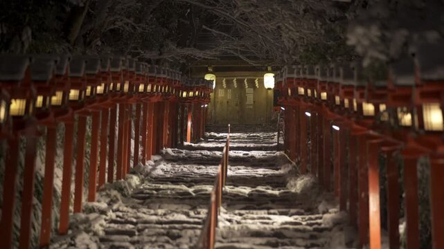 Kifune shrine stone stairs and traditional light pole in snowy winter night. Snow in Kyoto, Japan.