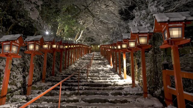 Kifune shrine stone stairs and traditional light pole in snowy winter night. Snow in Kyoto, Japan.