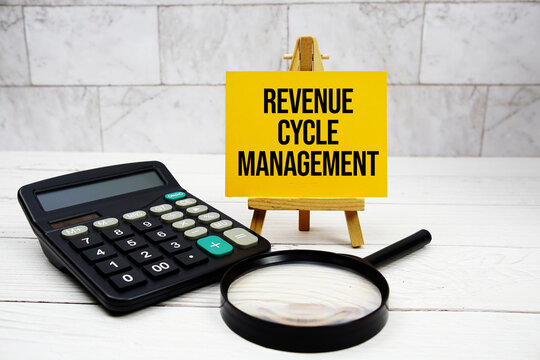 Revenue Cycle Management text with calculator and magnifying glass