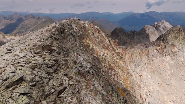Aerial view of hikers trekking up Vall de Molieres towards Molieres peak with Aneto glacier view in Spanish Pyrenees