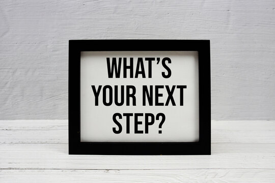 What's Your Next Step? text written on wooden frame