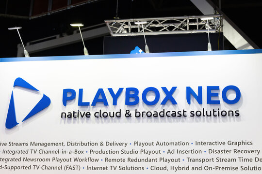 Amsterdam, Netherlands - September 11, 2026: PlayBox Neo native cloud and broadcast solutions display with blue logo and technical services text at IBC technology exhibition booth
