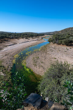 Aerial View of a Shallow Riverbed in an Arid Landscape