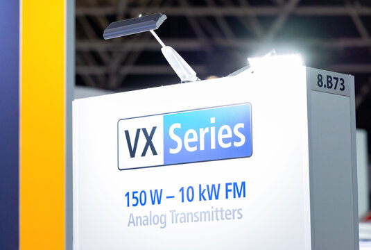Amsterdam, Netherlands - September 11, 2026: VX Series sign promoting 150 W to 10 kW FM analog transmitters at IBC technology exhibition booth display