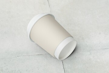 Fototapeta na wymiar Blank paper cup on the ground