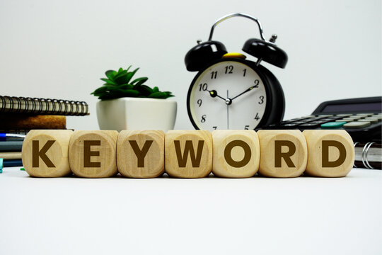 KEYWORD alphabet letters with alarm clock and calculator on white background