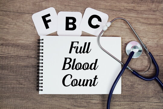 FBC Full Blood Count text written on notepad with stethoscope on wooden background