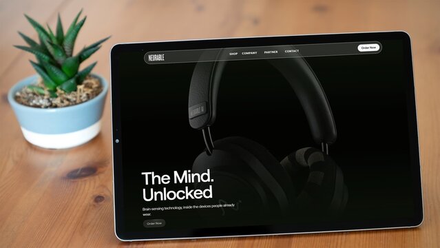 Izmir, Turkey - 9 Oct 2026: Neurable website on a tablet on a wooden table next to a potted succulent, the Boston neurotechnology company building brain computer interfaces into headphones