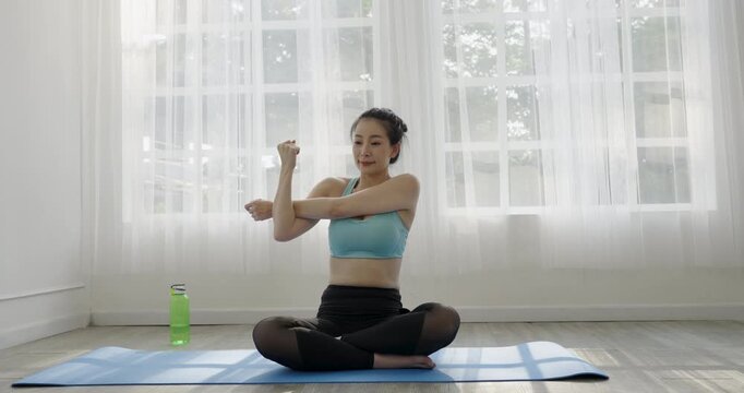 Portrait of young beautiful asian korean woman warmup exercise workout yoga position. Healthcare influencer at home minimal lifestyle. Yoga meditation teacher and wellness