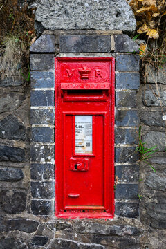 Llanwddyn, Wales, UK - September 7, 2026; Victorian wall mounted red post office letter box with Queen Victoria cypher