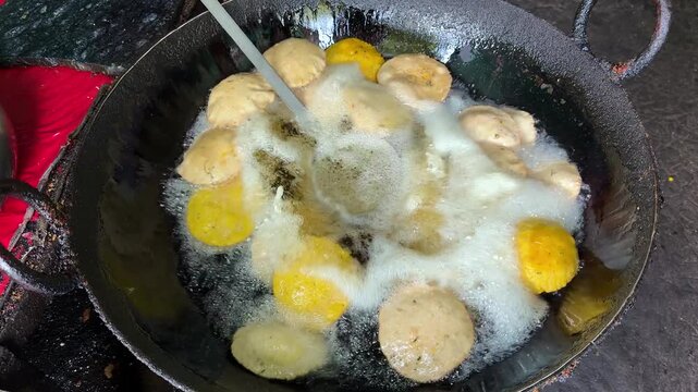 Indian street food puri or bedai frying in hot oil large wok 4k video footage