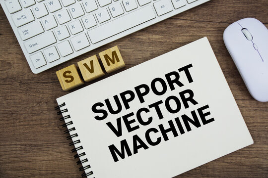 SVM Support Vector Machine message with keyboard and optical mouse on wooden background