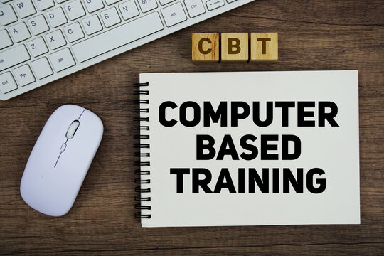CBT Computer-Based Training message with keyboard and optical mouse on wooden background