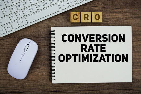 CRO Conversion Rate Optimization message with keyboard and optical mouse on wooden background