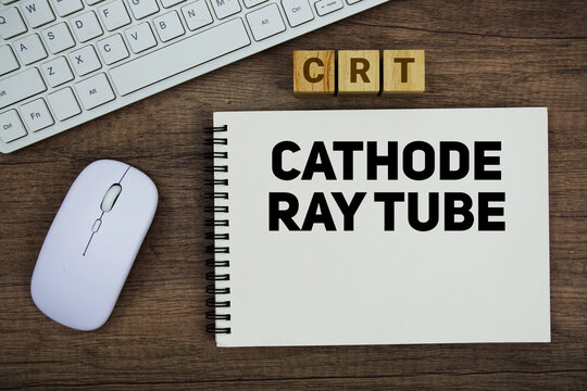 CRT Cathode Ray Tube message with keyboard and optical mouse on wooden background