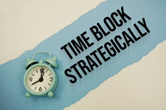 Time Block Strategically with alarm clock on blue background
