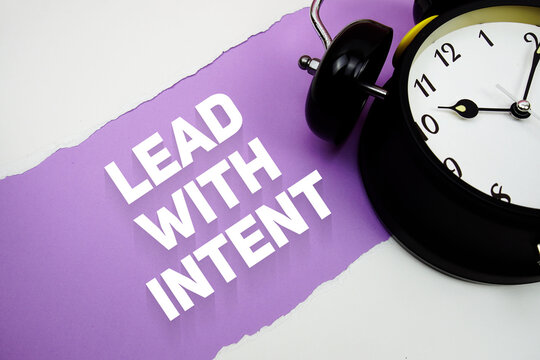 Lead With Intent with alarm clock on purple background