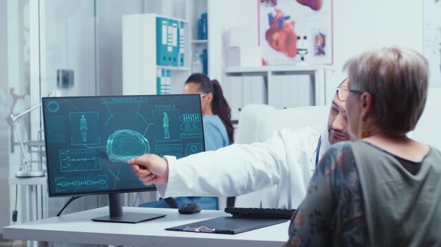 Physician uses a pointer to review a digital brain scan with an older woman during a medical consultation, combining diagnostic imaging with patient education.