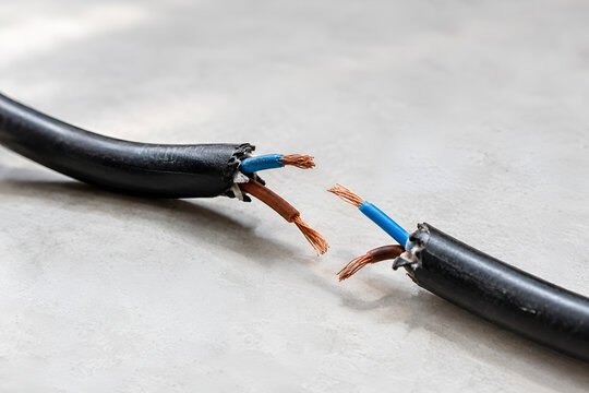 Broken Electrical Cable with Exposed Copper Wires on White Background