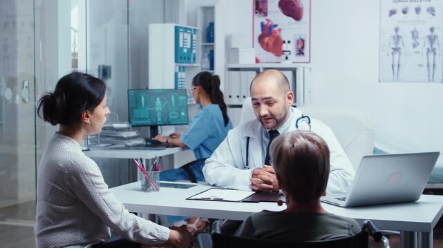 Clinic appointment with older wheelchair patient and companion