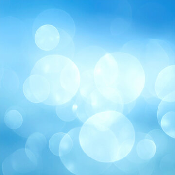 A serene blue background featuring soft bokeh light orbs, capturing a dreamy, ethereal atmosphere. This artistic texture with nobody is ideal for uplifting digital design projects. No people.