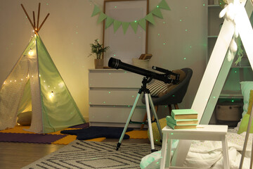 Childhood curiosity and astronomy, telescope in a cozy bedroom with a play tent for learning science and exploring the night sky at home © Pixel-Shot