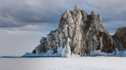 Majestic Shamanka Rock rises above frozen Lake Baikal near Khuzhir village in Irkutsk Oblast, Russia, showing dramatic icicles, textured limestone crags, and endless snowy ice expanses © TravelFlow