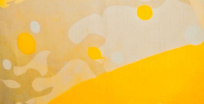 An abstract fabric pattern featuring circular ornaments, with bright yellow and off-white as the dominant colors. A minimalist design with a fluid feel.