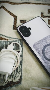 cellphone charger, cellphone. 2 things that humans really need in this day and age 