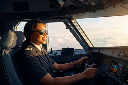 Sunlit cockpit pilot guiding an aircraft above the clouds