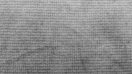 Grey textured grid fabric surface with small square pattern, close-up full frame background © widyuta