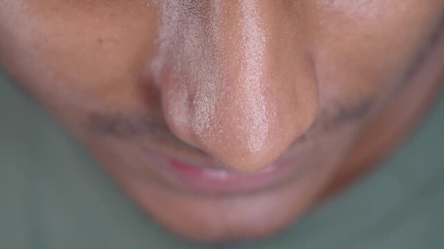 Close-up view of a man's face showing details of his nose and chin