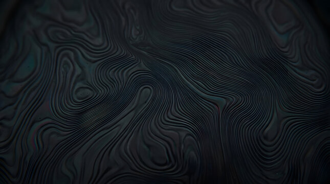 Dark damascus steel texture showing wavy abstract line patterns on metallic surface