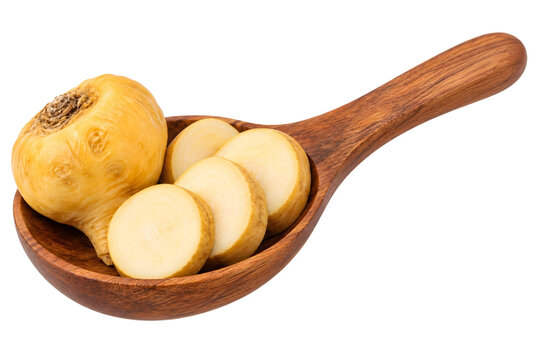 Whole yellow maca root and thick sliced pieces in wooden spoon isolated on transparent background