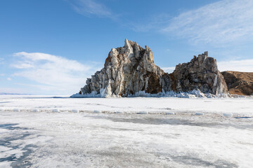 Majestic Shamanka Rock stands on frozen Lake Baikal near Khuzhir village in Irkutsk Oblast, Russia, surrounded by snowy ice and bright blue sky during a cold winter day with icy shore © TravelFlow